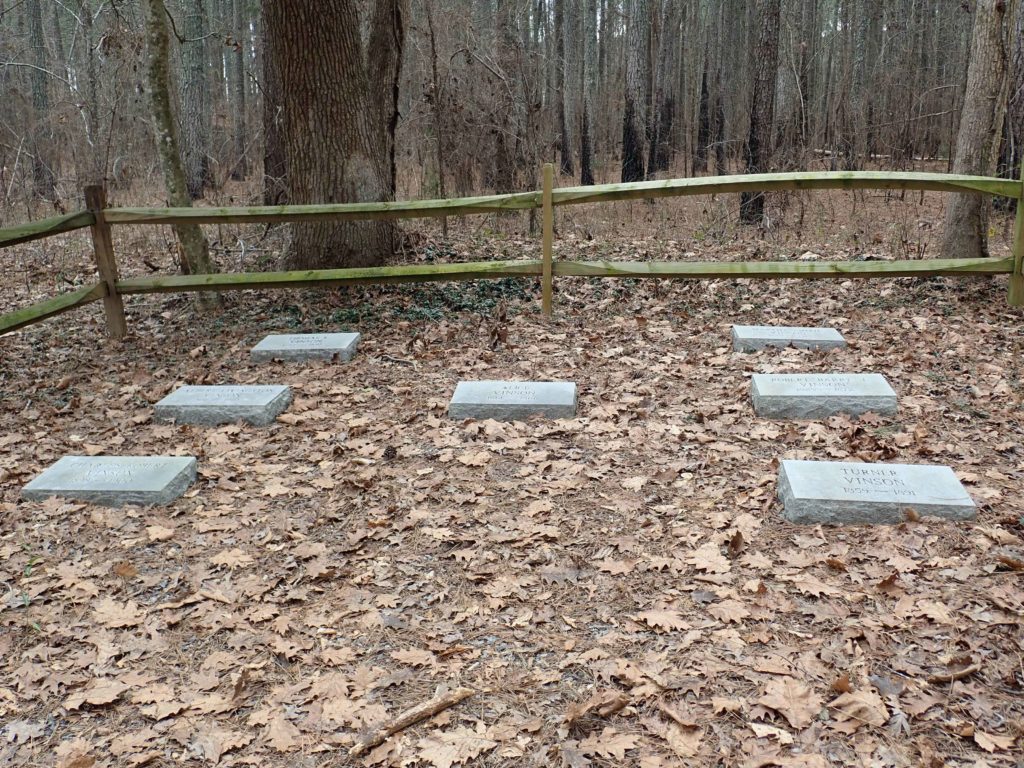 seven flat gravestones at top of Summit Loop